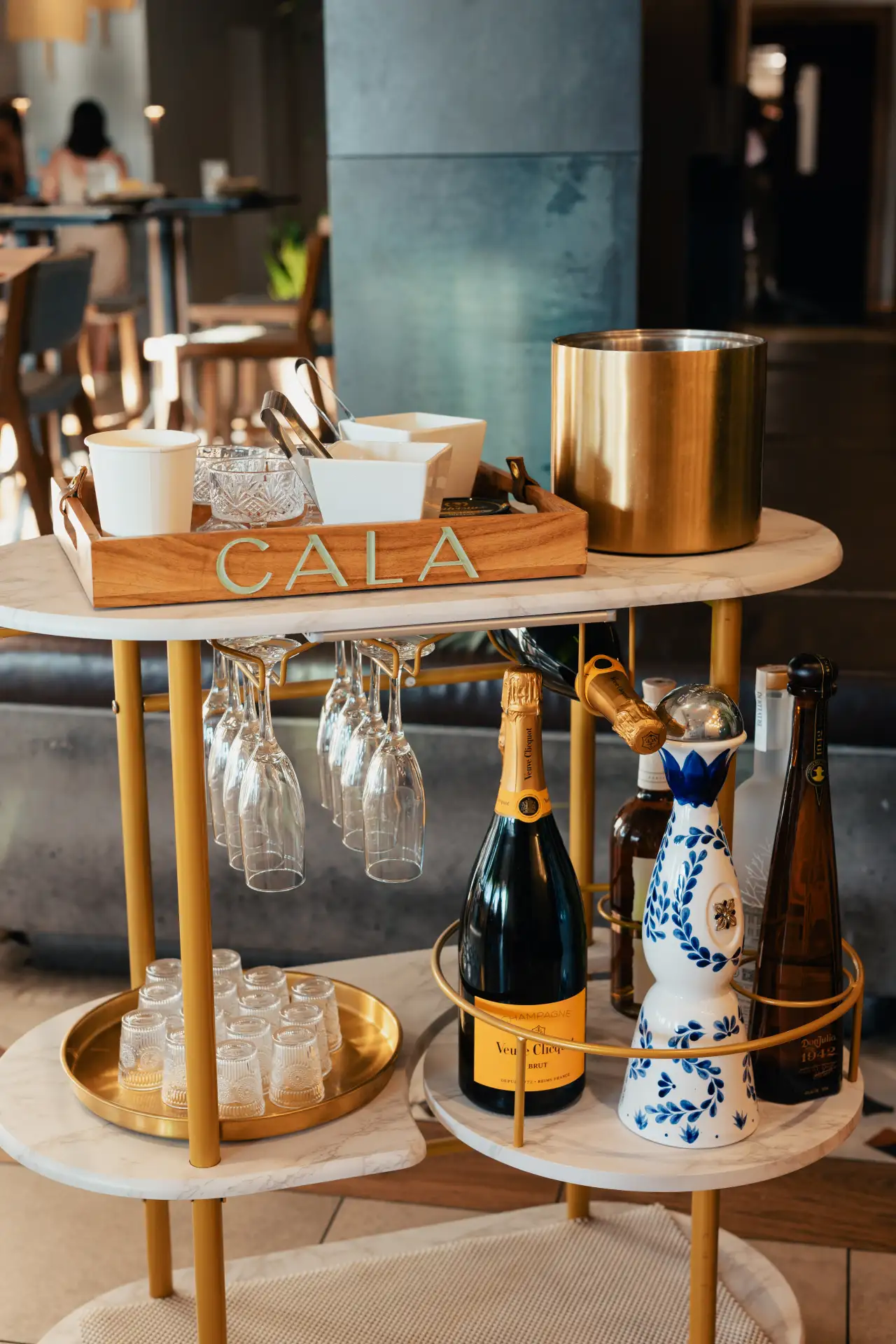 CALA's bar cart with champagne and tequila