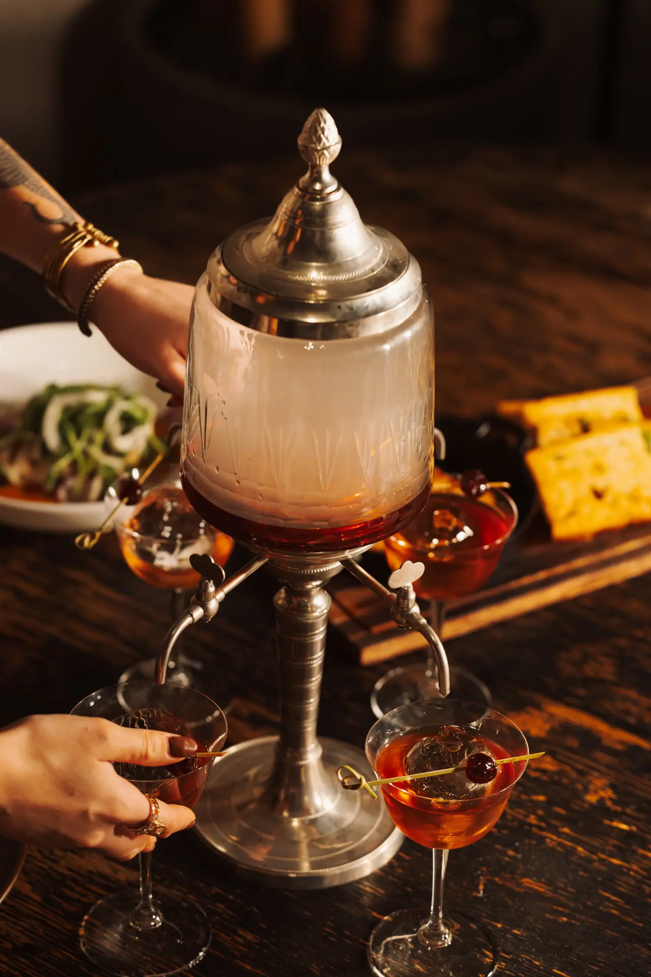 Amber cocktails poured from a vintage dispenser