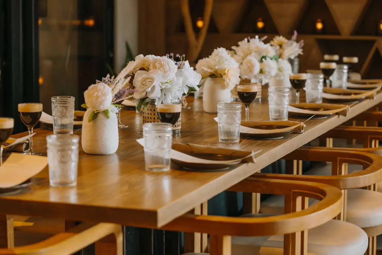A long table set with white florals for a private event at CALA