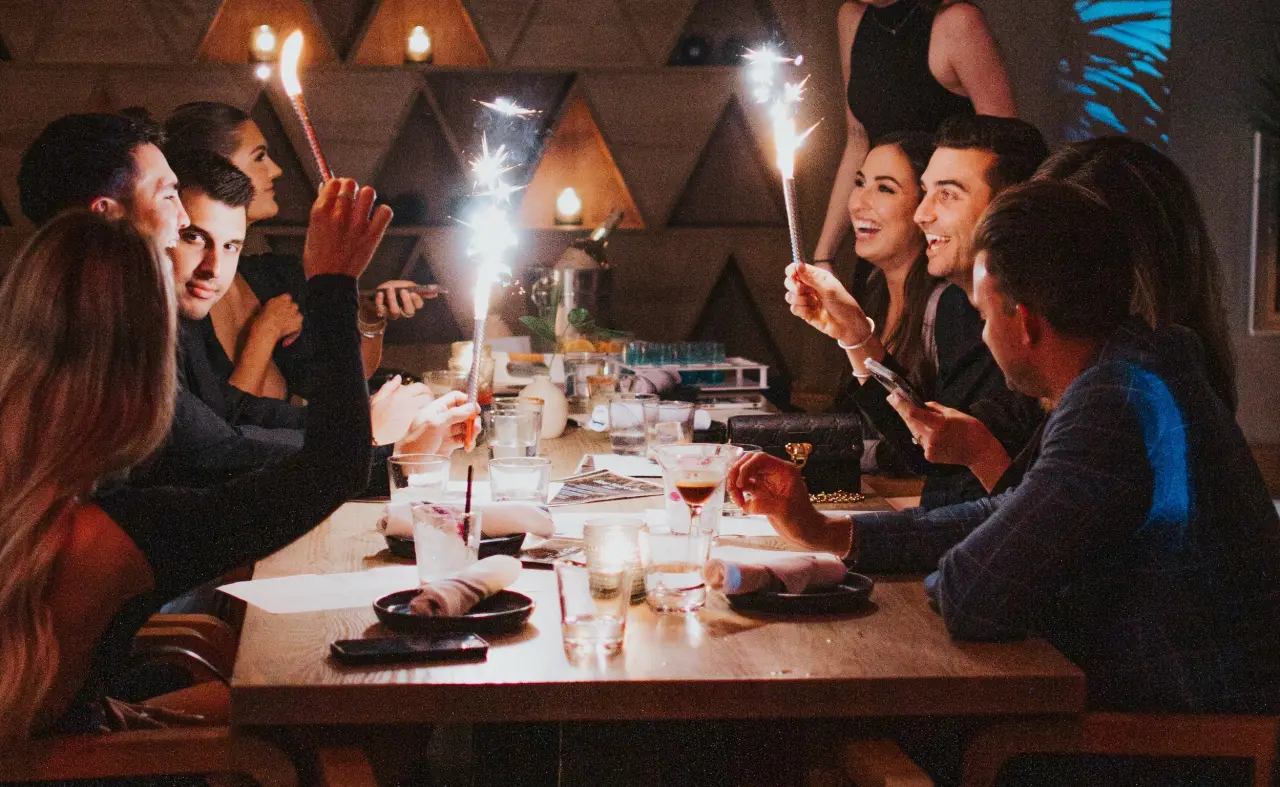 A long table with sparklers at night