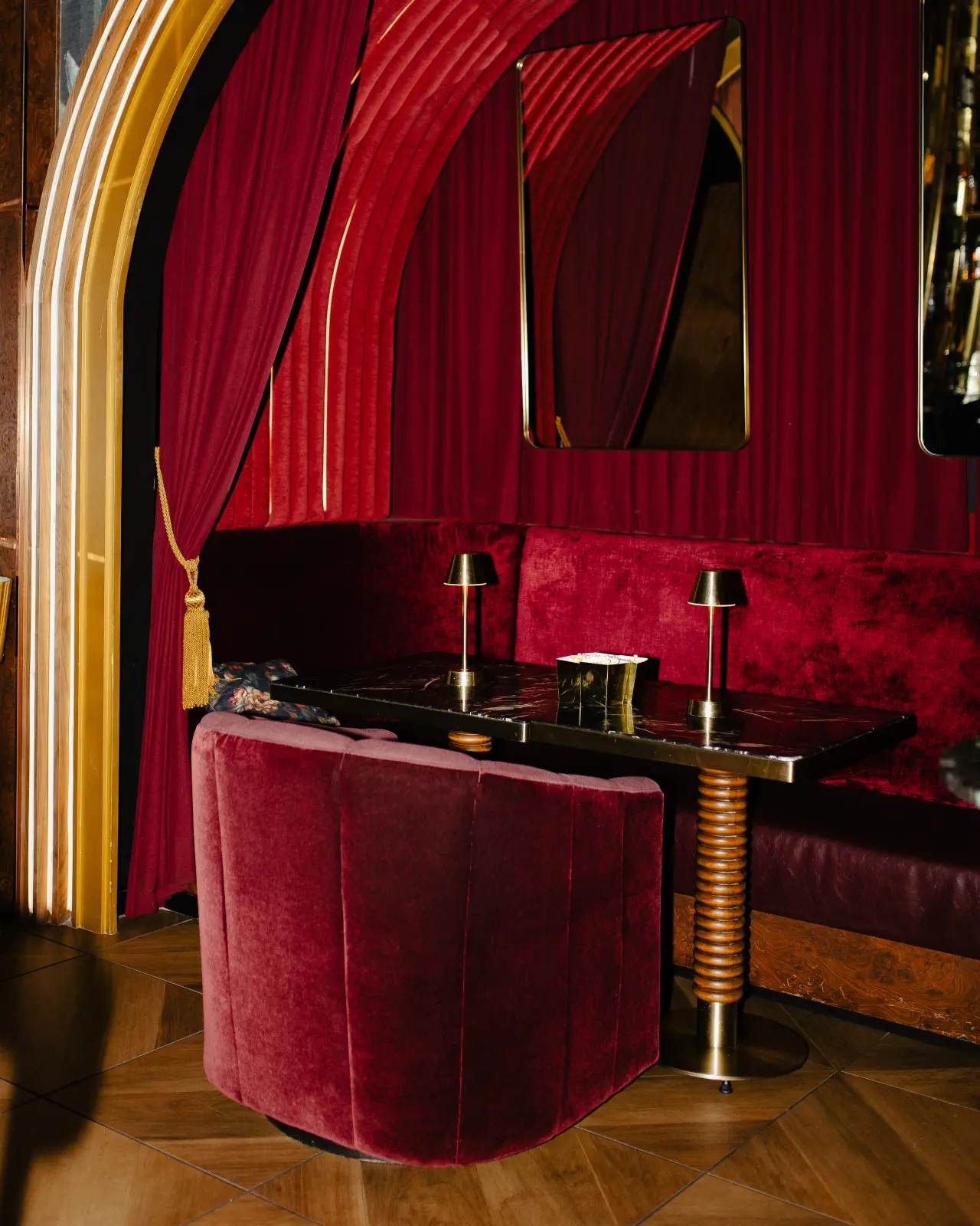 A red velvet booth behind the curtain