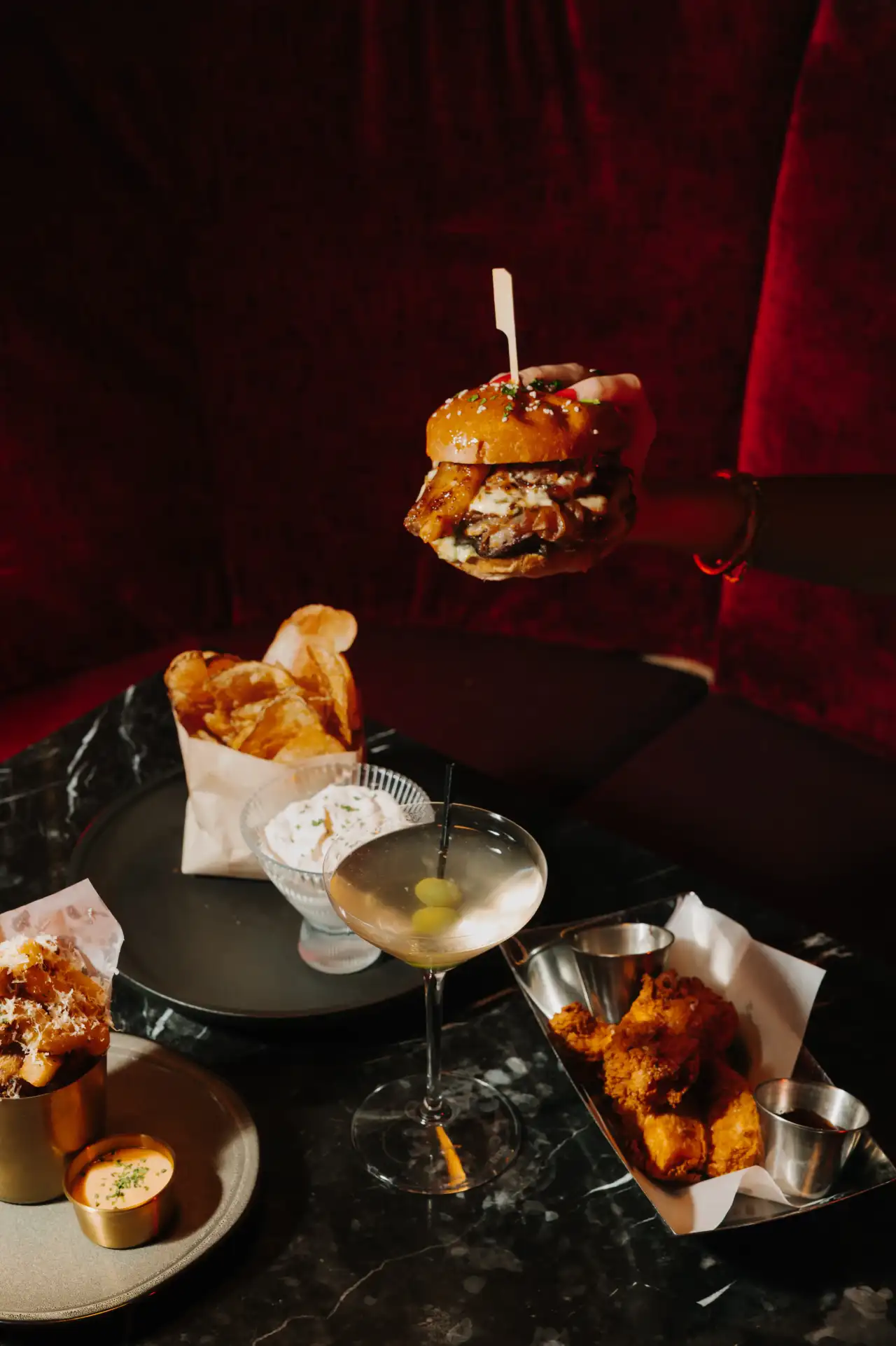 A burger, fries and a martini at happy hour