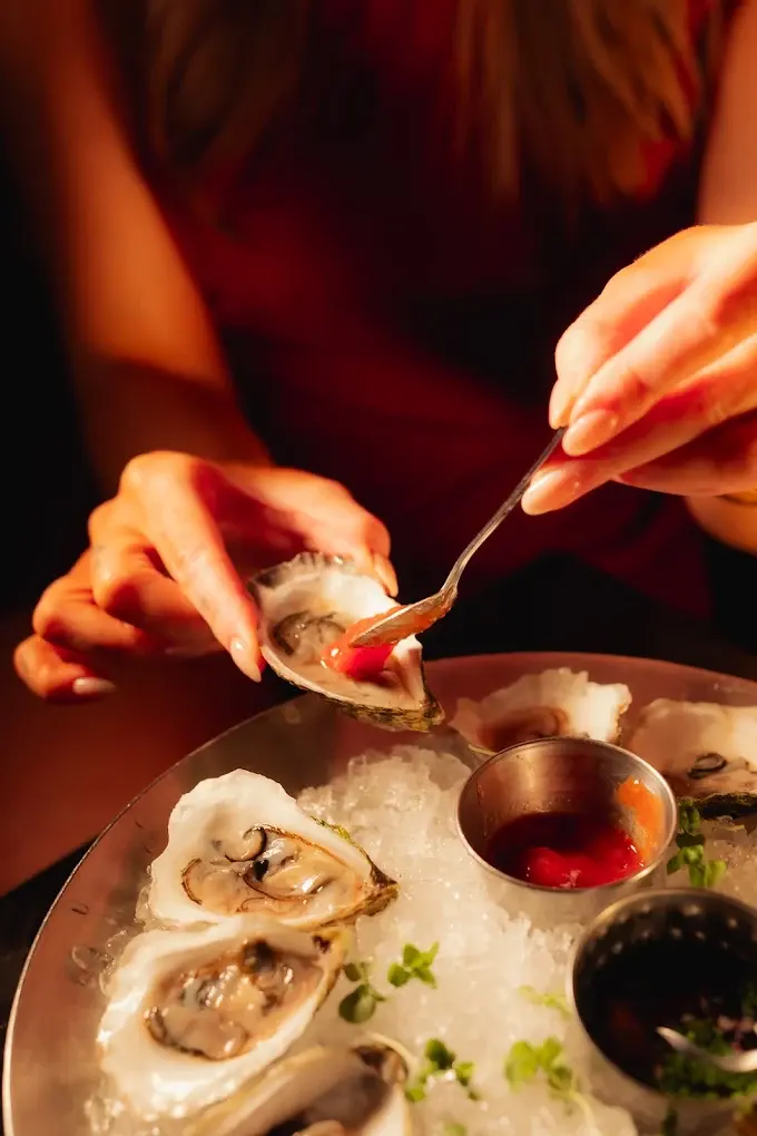 Oysters on ice with cocktail sauce